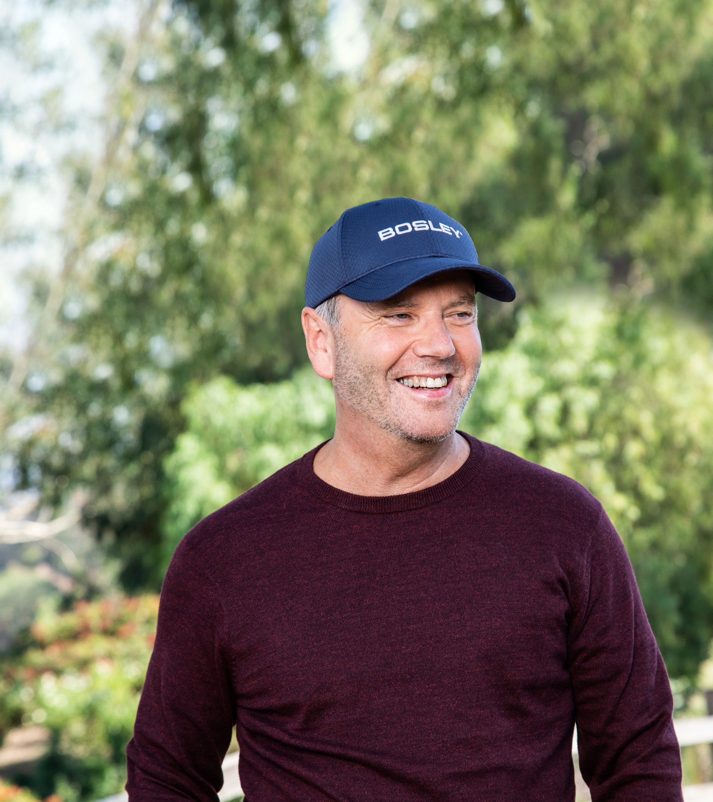 Bosley Results Photo Man Wearing Bosley Cap Outside Tree Background